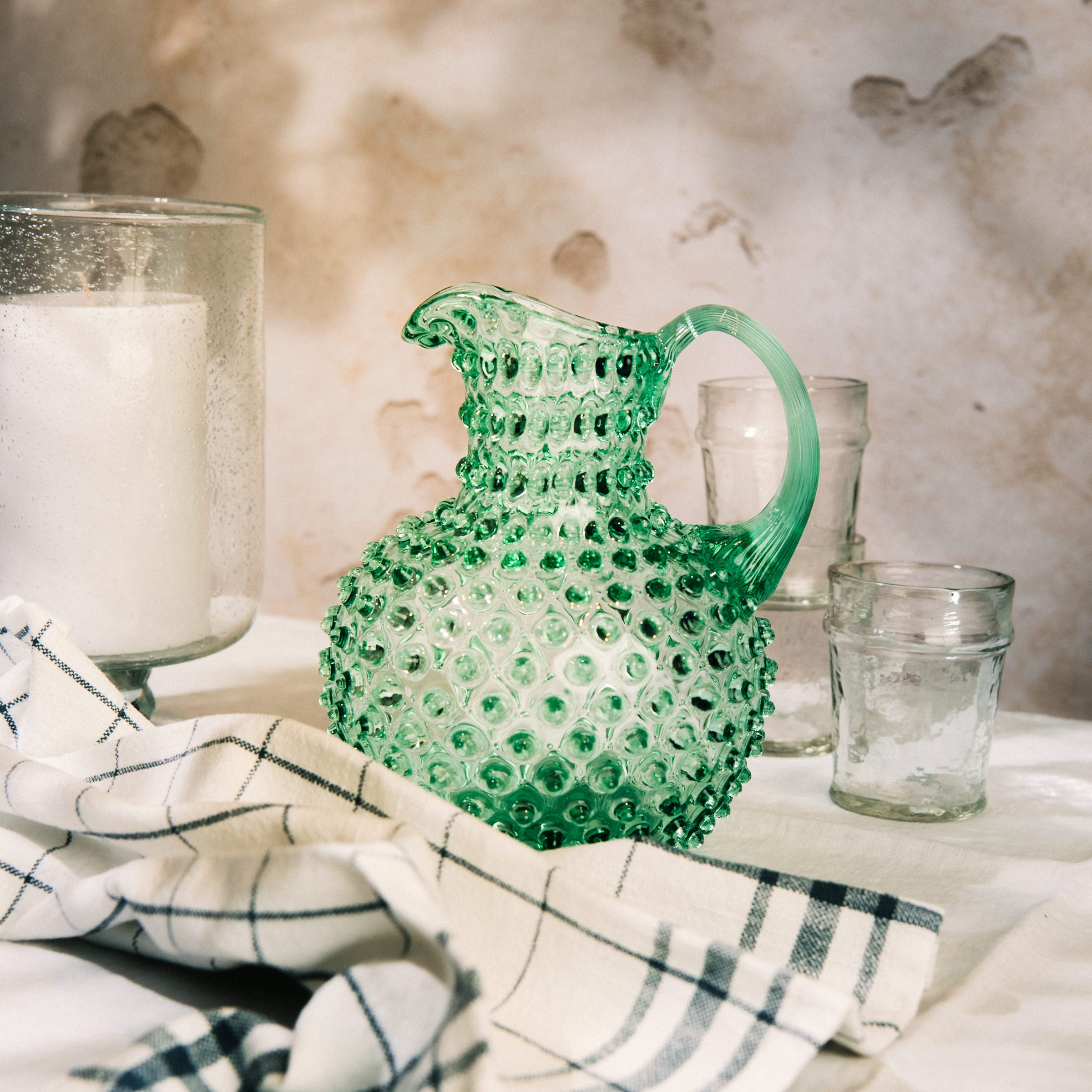 Hobnail Glass Pitcher in Capri Sea on a table at Addison West