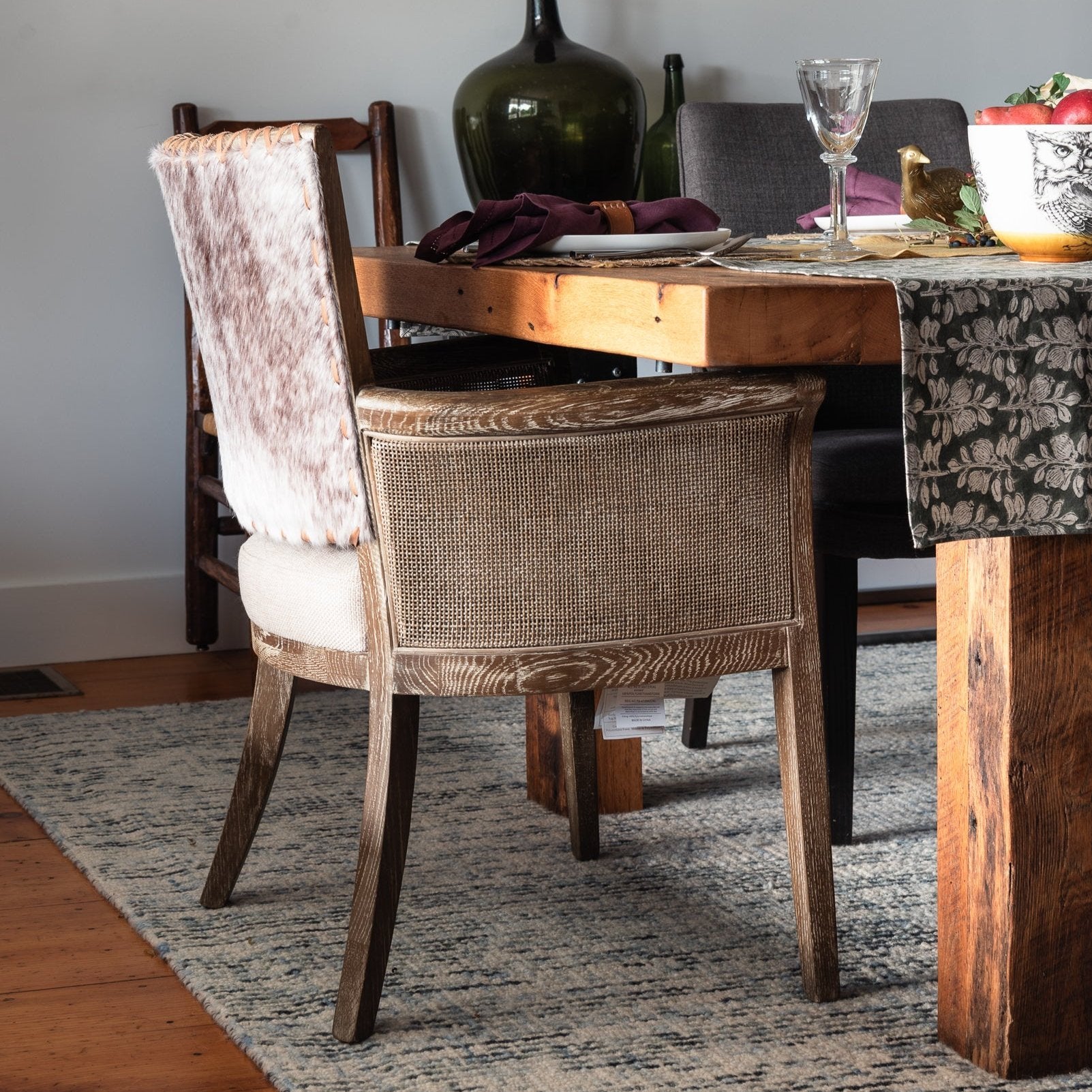 Open Range Hair on Hide Dining Chair at a rustic table.