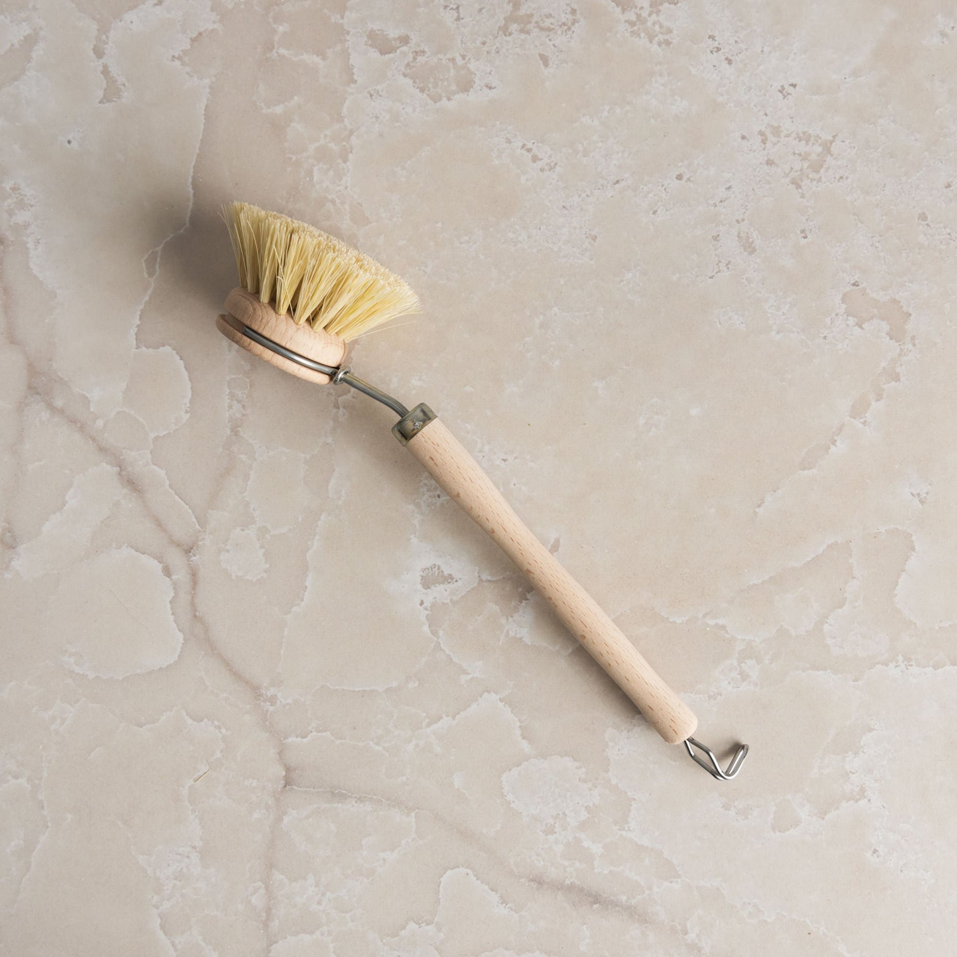 Redecker Natural Fiber Dish Brush on a marble table at Addison West