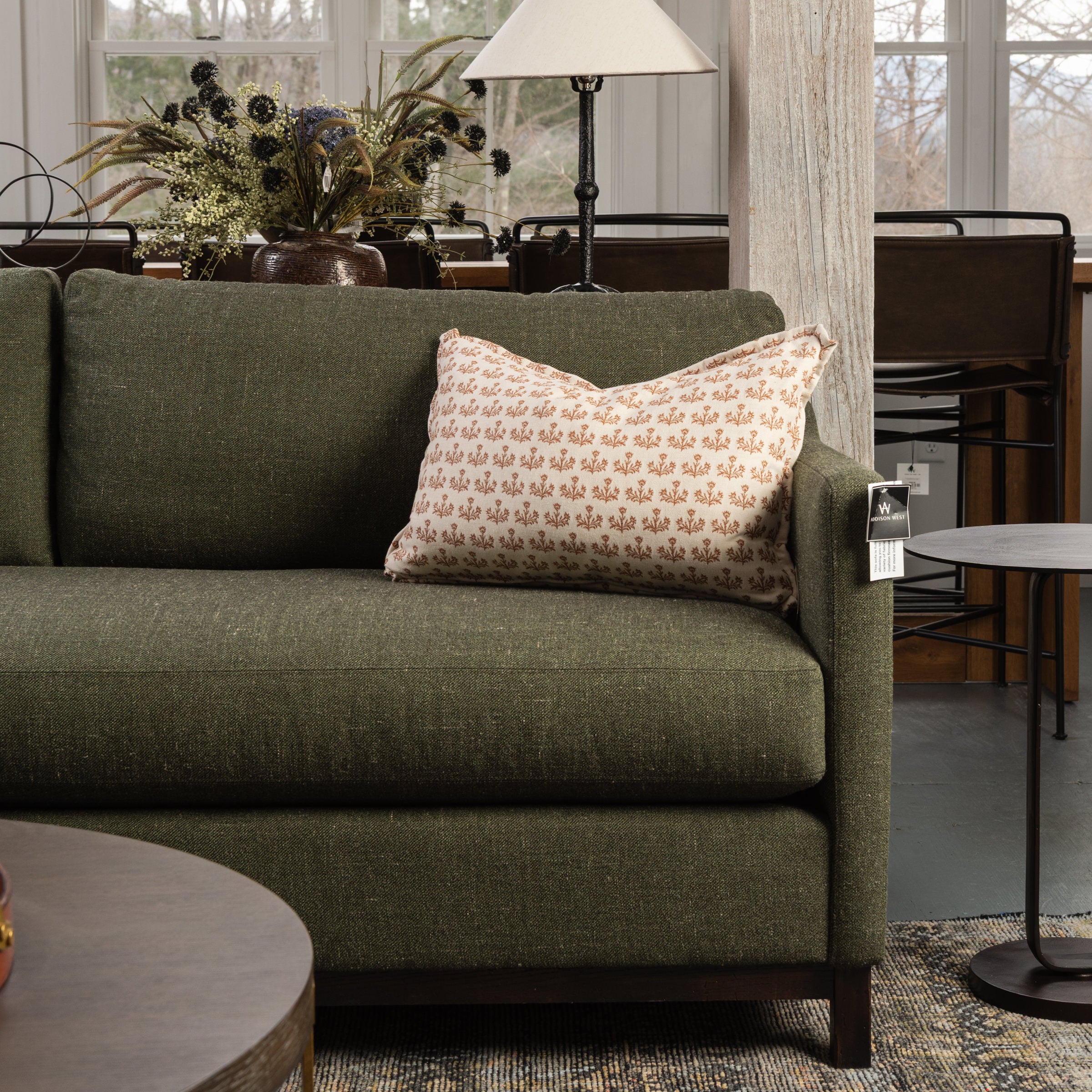 Tilda Custom Lumbar Throw Pillow on a green sofa at Addison West