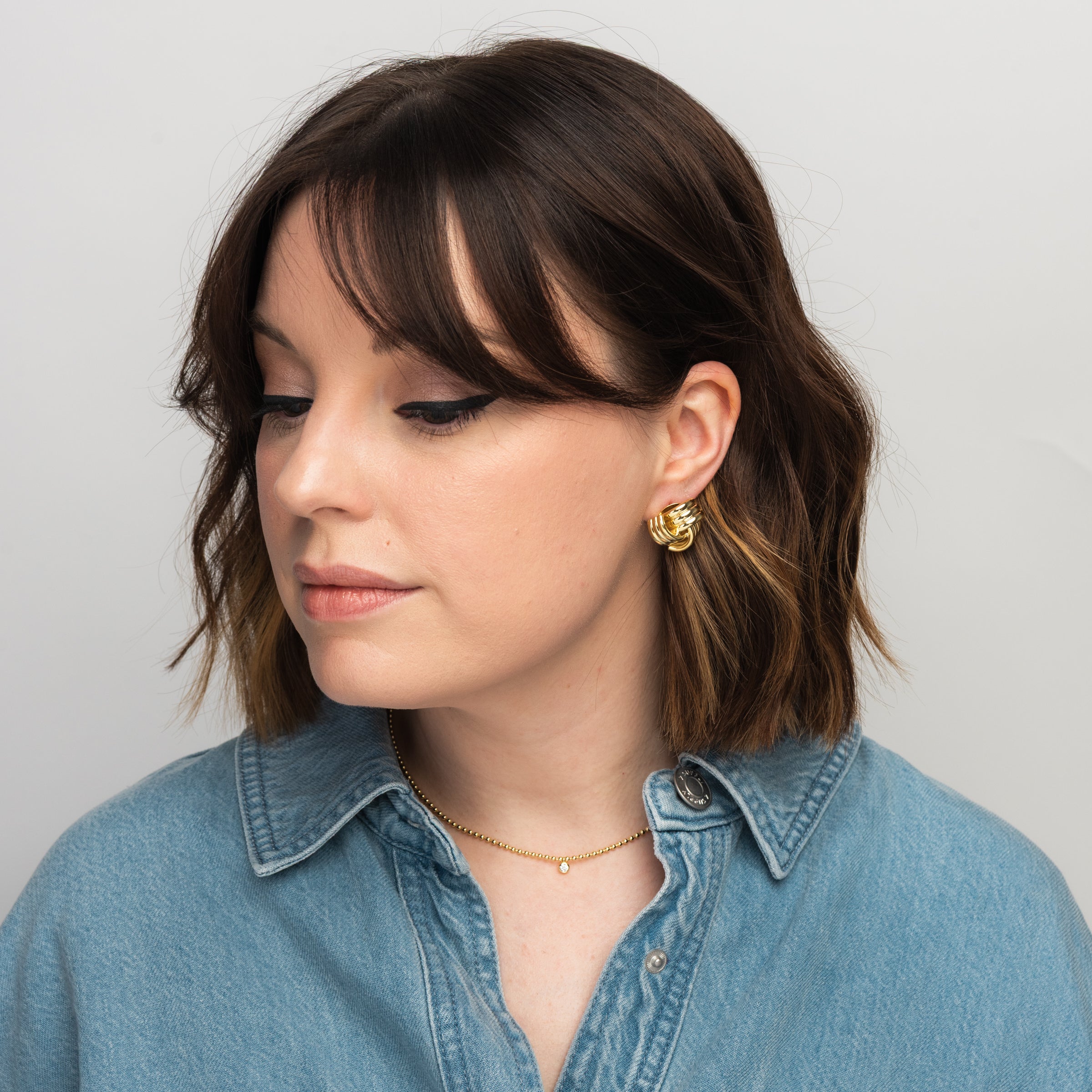 Elli Parr Knotted Stud in Gold on a model at Addison West