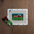 Vermont Pastoral Mini Needlepoint Kit on a wood table at Addison West