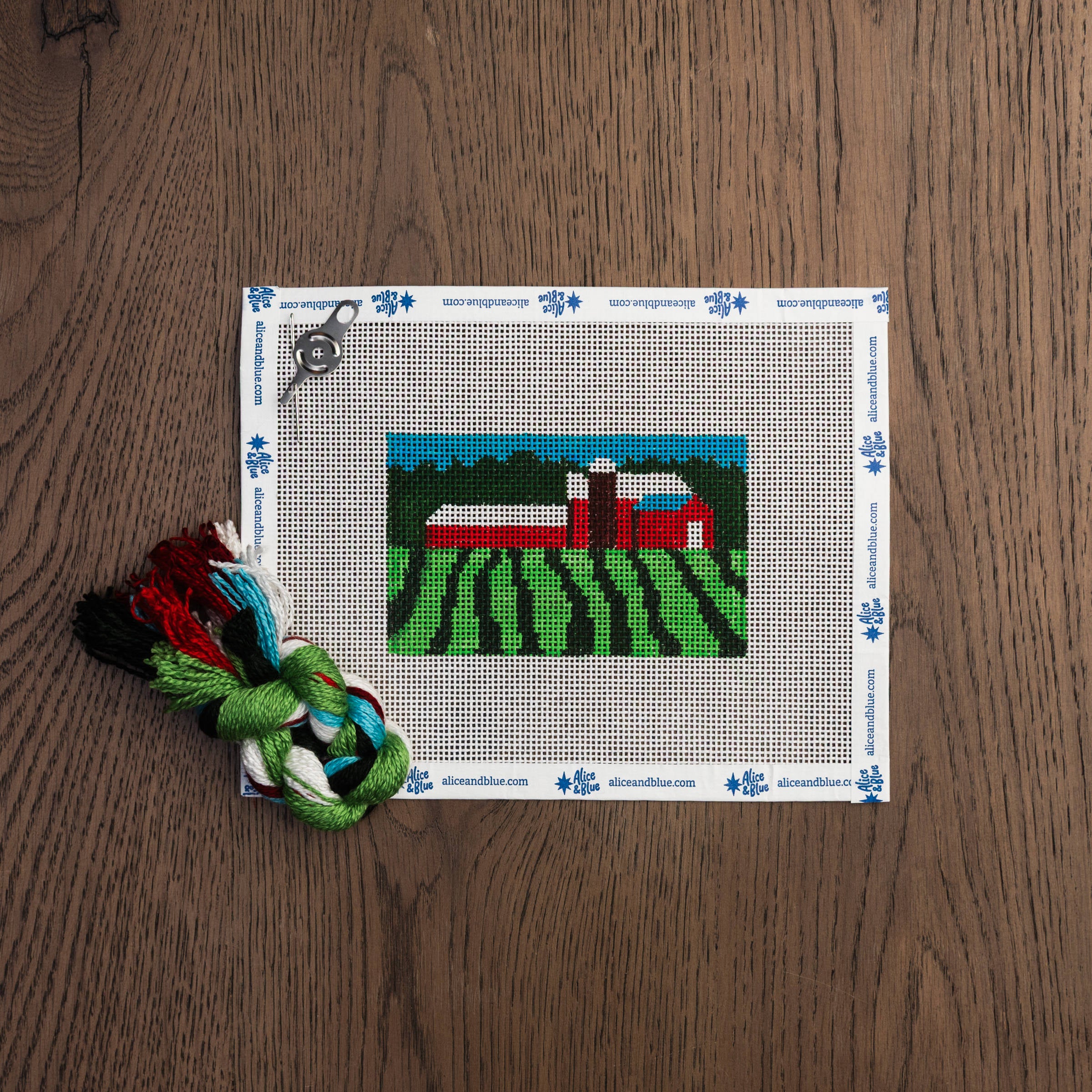 Vermont Pastoral Mini Needlepoint Kit on a wood table at Addison West
