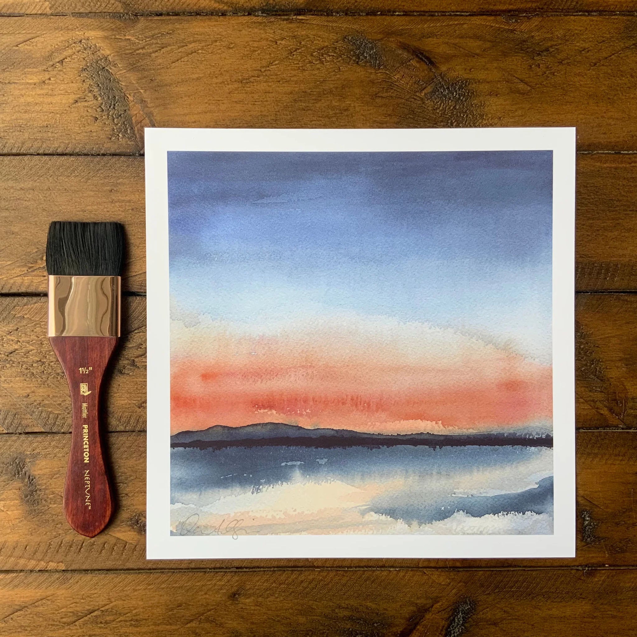 Alburgh Sunset Watercolor Painting by Deana Allgaier 8" x 8" on a wood table at Addison West