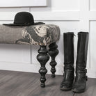 Alhambra Upholstered Gray Seat with Black Wood Legs Accent Bench against a white wall