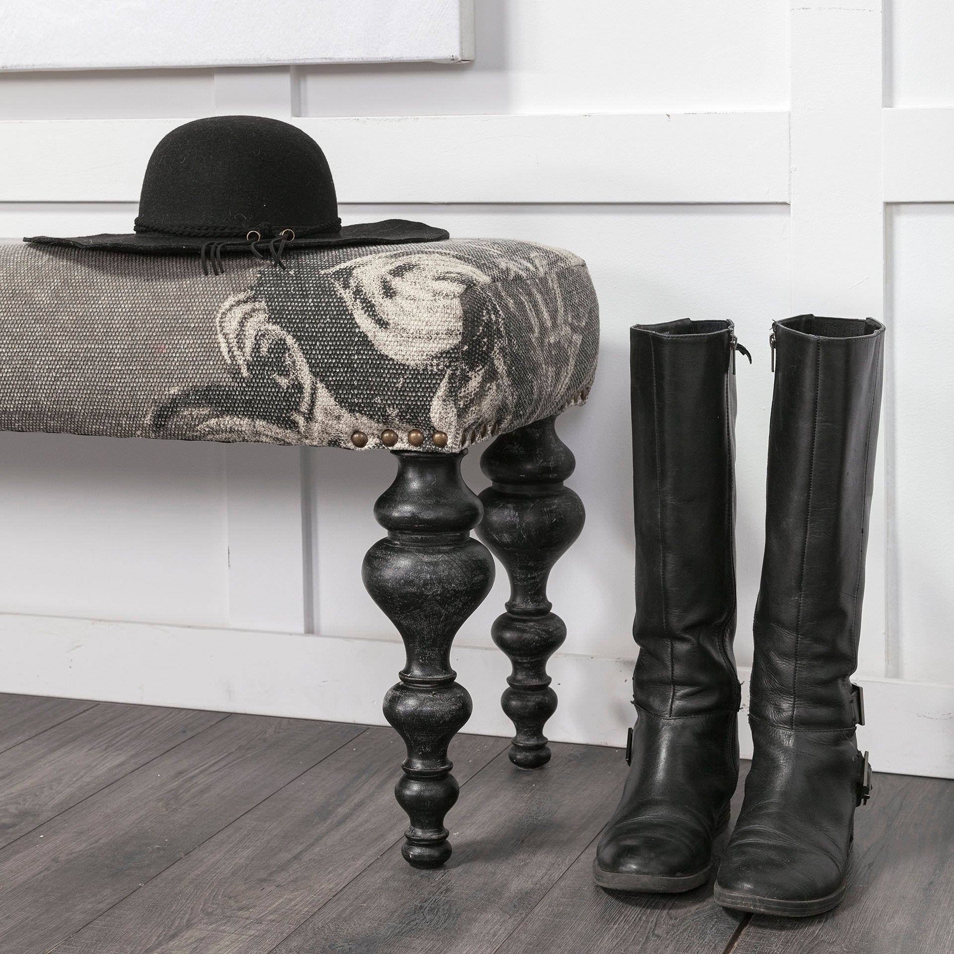 Alhambra Upholstered Gray Seat with Black Wood Legs Accent Bench against a white wall