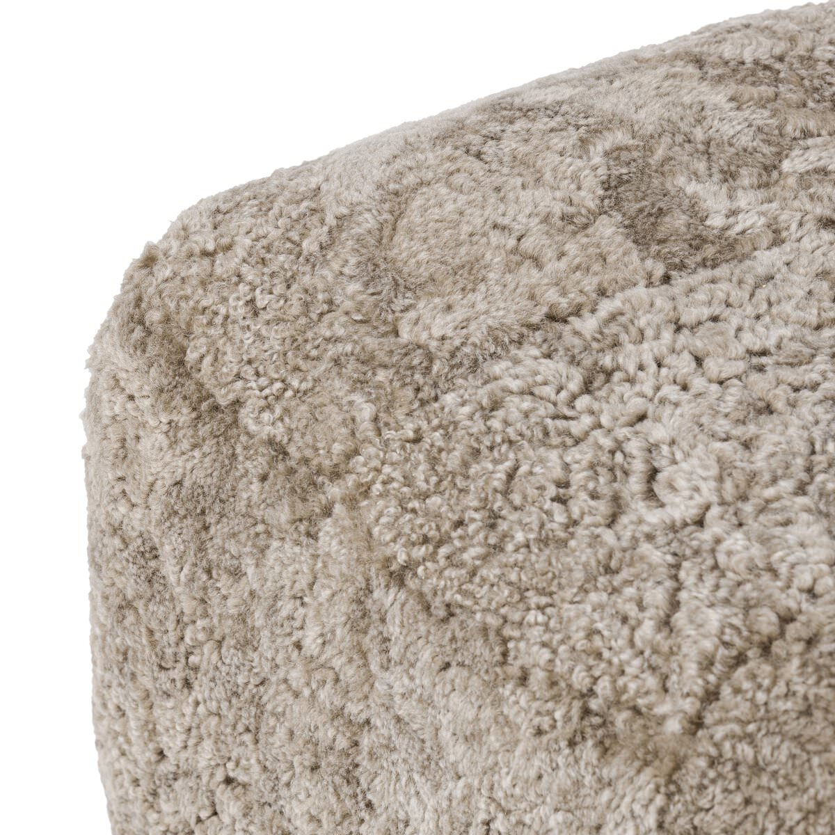Close up of Amber Lewis x Four Hands Oslo Ottoman in Taupe Shearling on a white background at Addison West