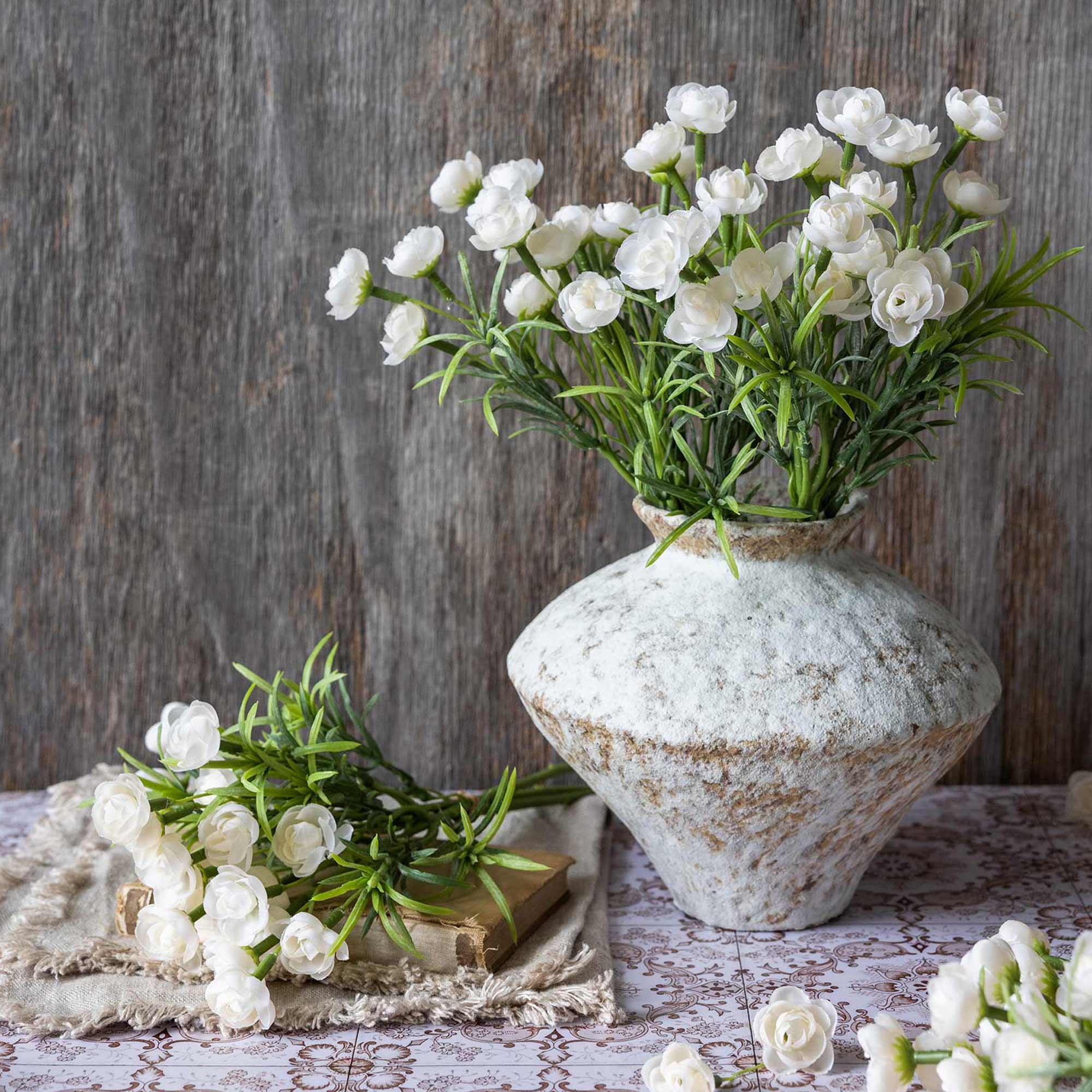 Abigail Ahern Faux Hellebore Bunch in White in a vase on a table at Addison West