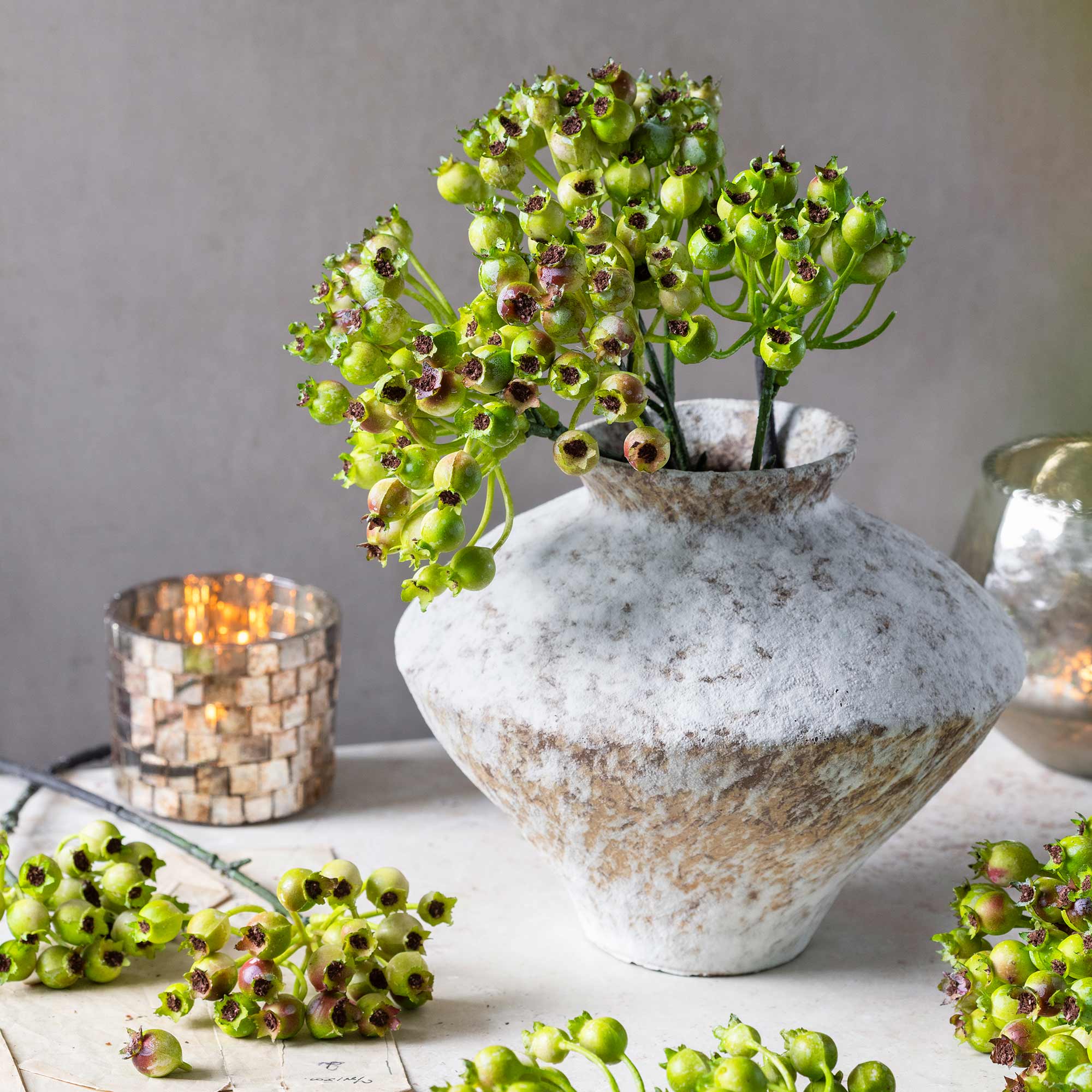 Abigail Ahern Faux Rosehip Bunch in Olive in a vase on a beige background at Addison West