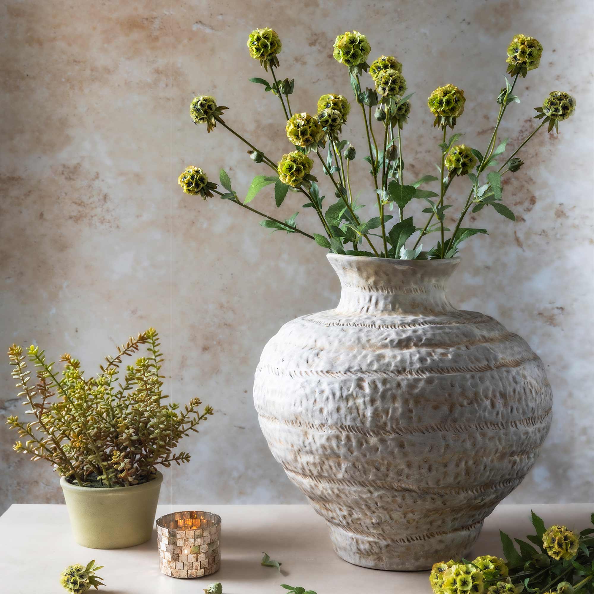 Abigail Ahern Faux Scabiosa in a vase on a beige background at Addison West