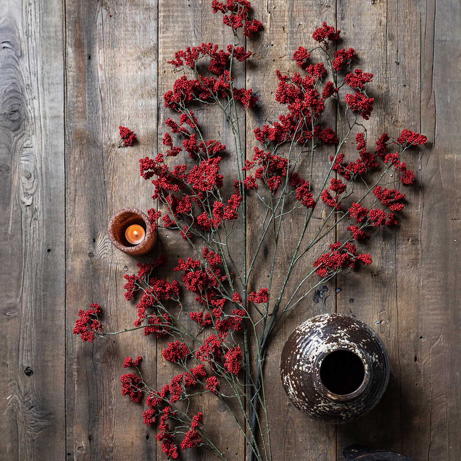 Abigail Ahern Artificial Wild Winter Berry in Ruby on a wood table at Addison West