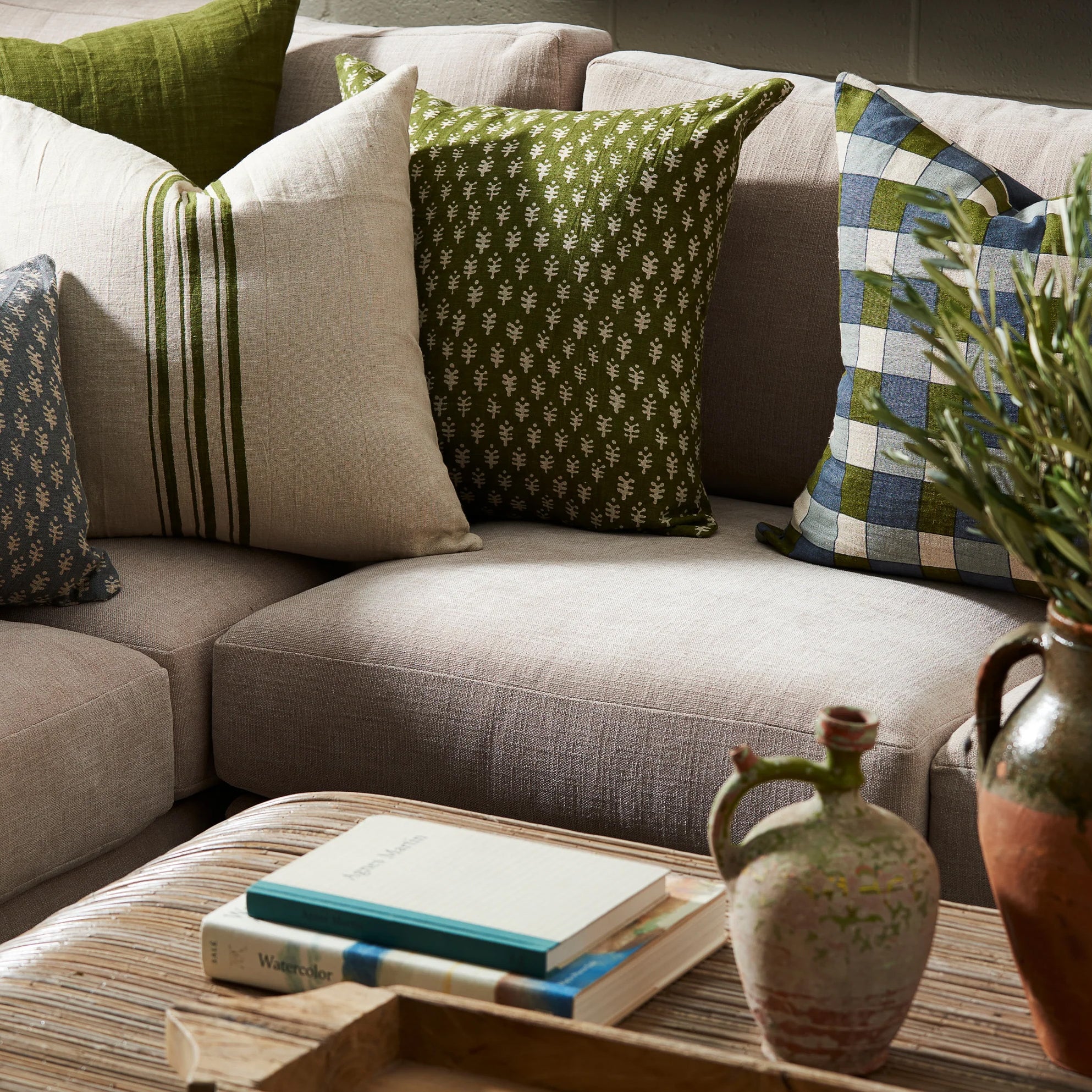 Astra Green 22" Square Pillow on a sofa at Addison West