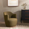 Four Hands brand Aurora swivel chair in olive boucle in a living space
