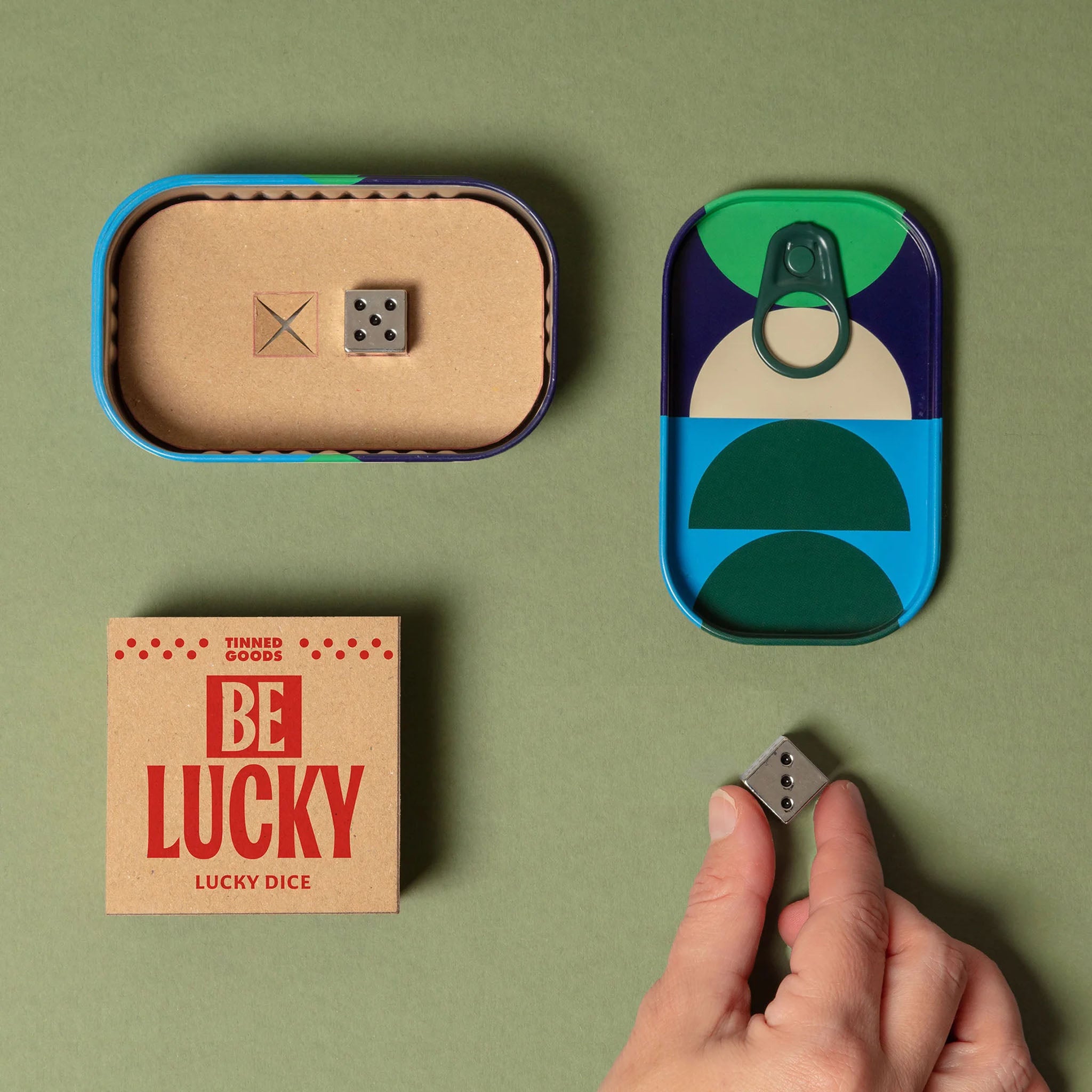 Be Lucky Travel Dice on a green background at Addison West