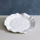 Beatriz Ball Melamine Havana Round Platter on a grey counter surface
