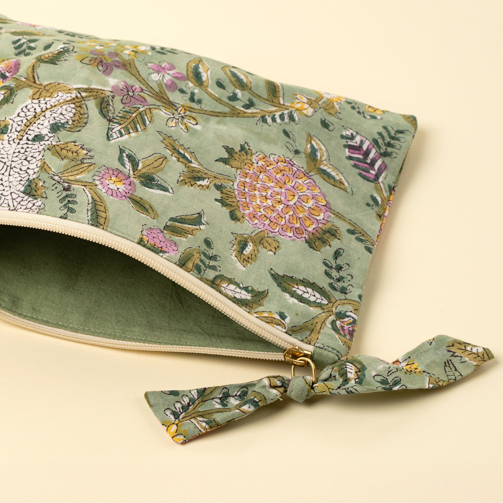 Block Print Pouch in Green on a beige background at Addison West