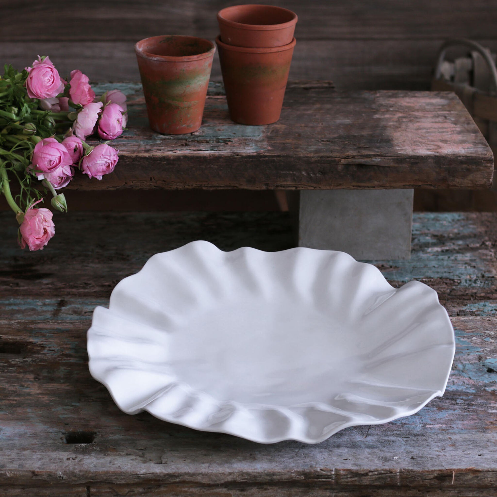 Beatriz Ball Bloom Large Round white melamine Platter on a wood surface with flowers