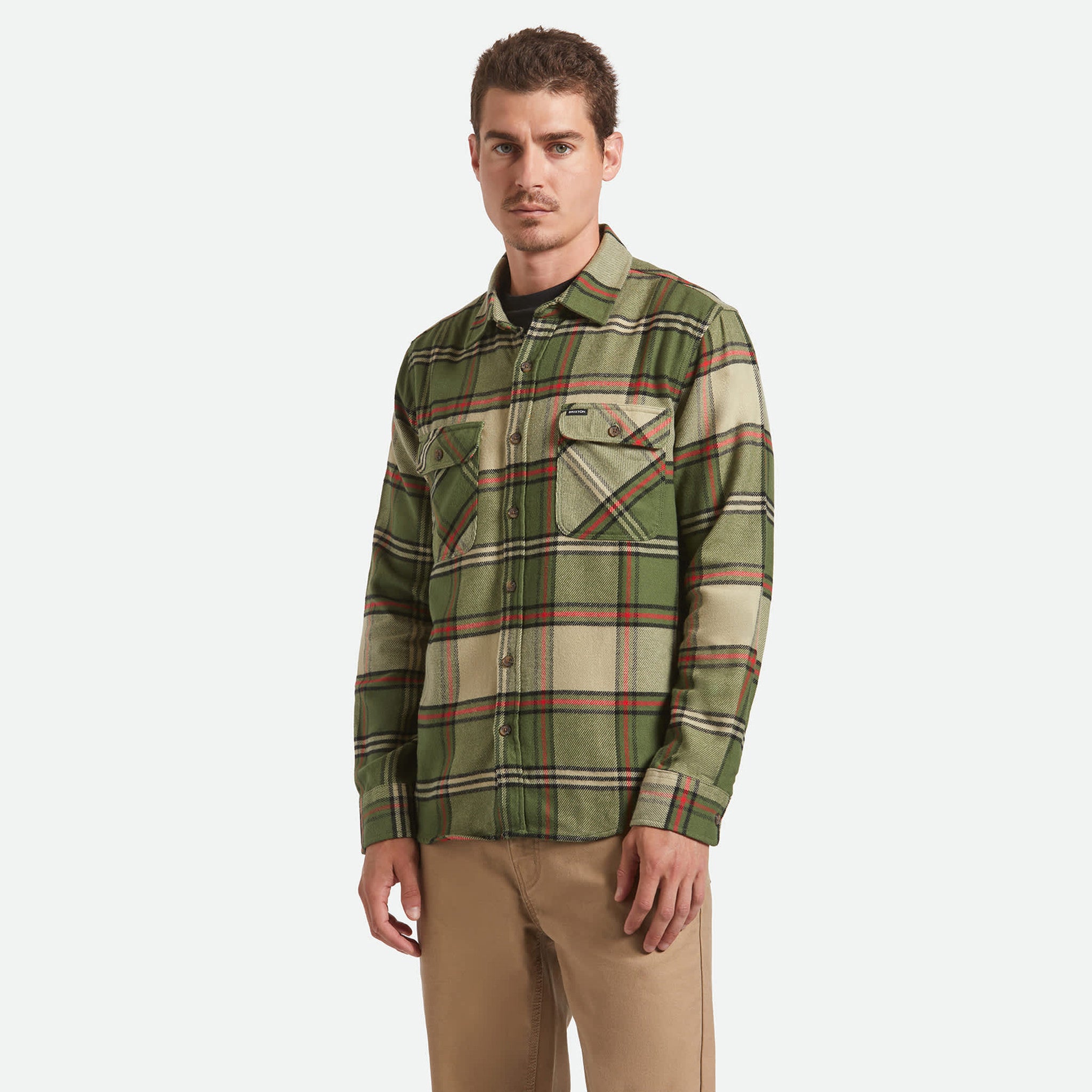 Man wearing a green plaid shirt on a white background