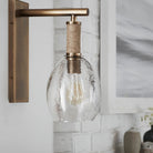 Kirk Nix Bronson Sconce In Brass on a white wall at Addison West