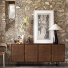 Four Hands furniture brand Carmel side board with four cane doors and metal legs. on a white background