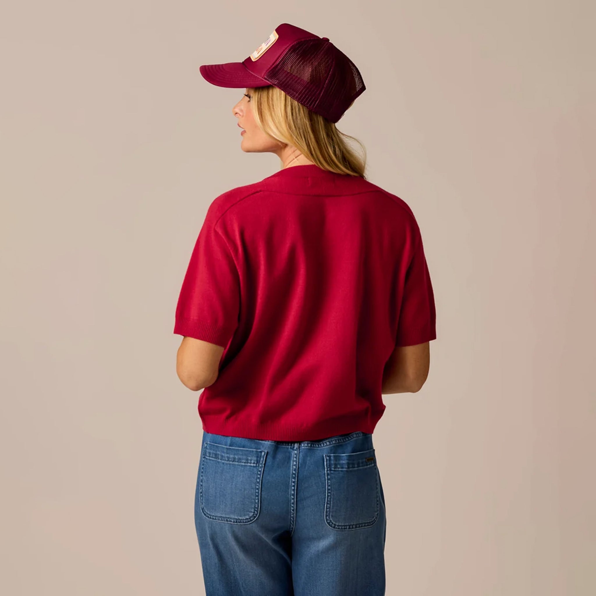 Female model shown wearing the Carve Josie Sweater Tee in Crimson on plain background.