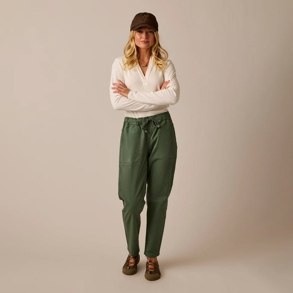 Female model shown wearing the Carve Zoe Twill Pant in Laurel on plain background.