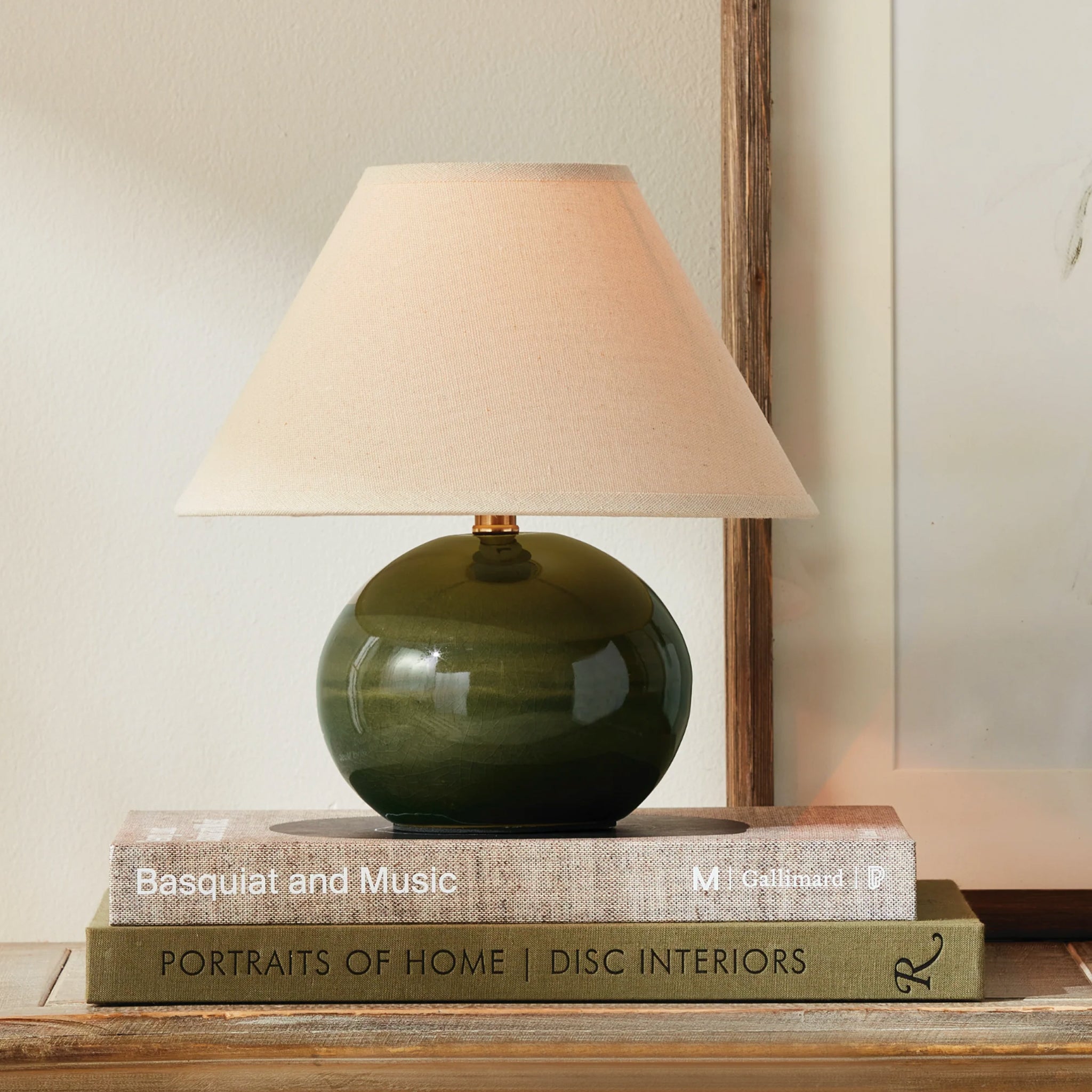 Charlie Mini Lamp in Green on a table at Addison West