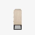 White washed wood six drawer dresser with metal base on a white background