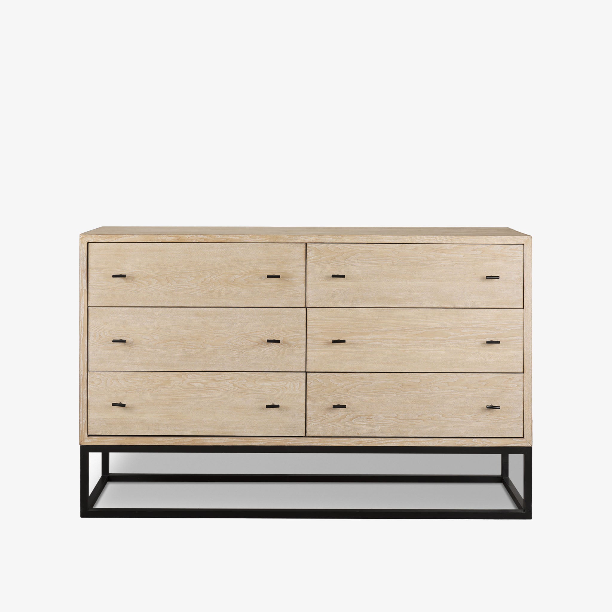 White washed wood six drawer dresser with metal base on a white background