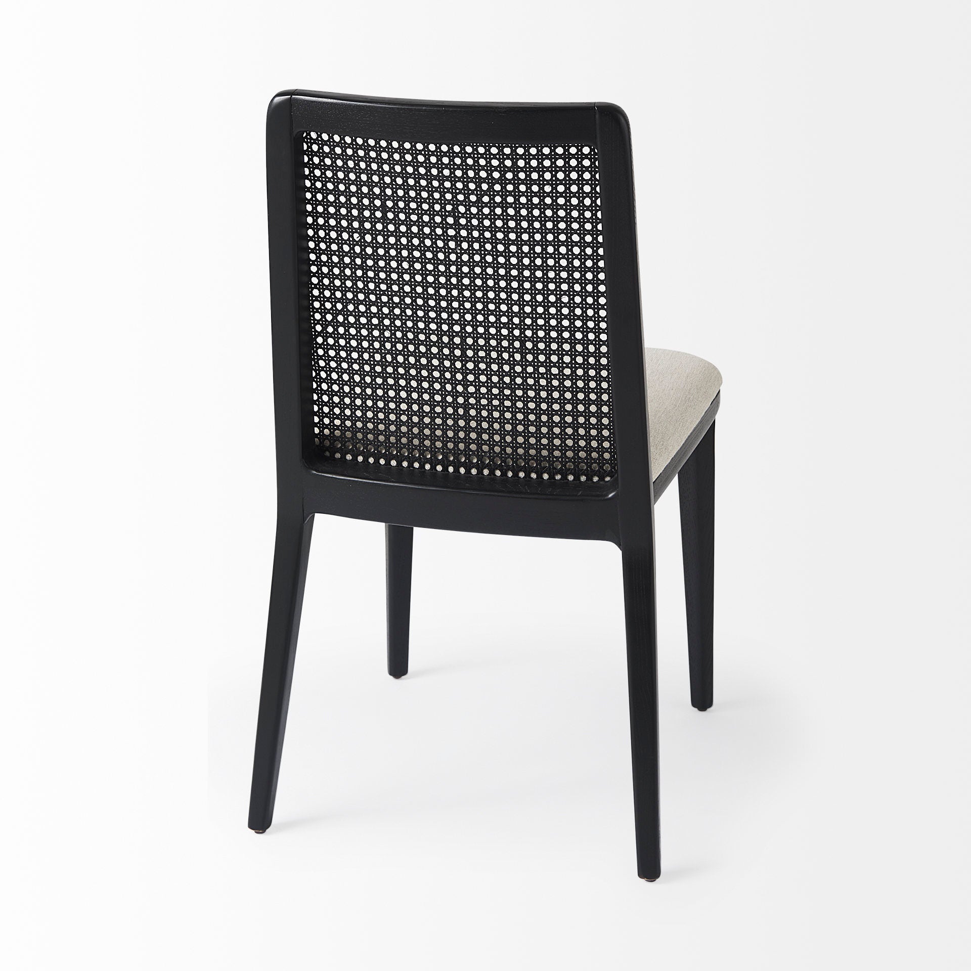 Clara Black Wood W/ Cream Fabric Seat and Cane Back Armless Dining Chair on a white background