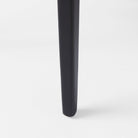 Close up of Clara Black Wood W/ Cream Fabric Seat and Cane Back Armless Dining Chair on a white background