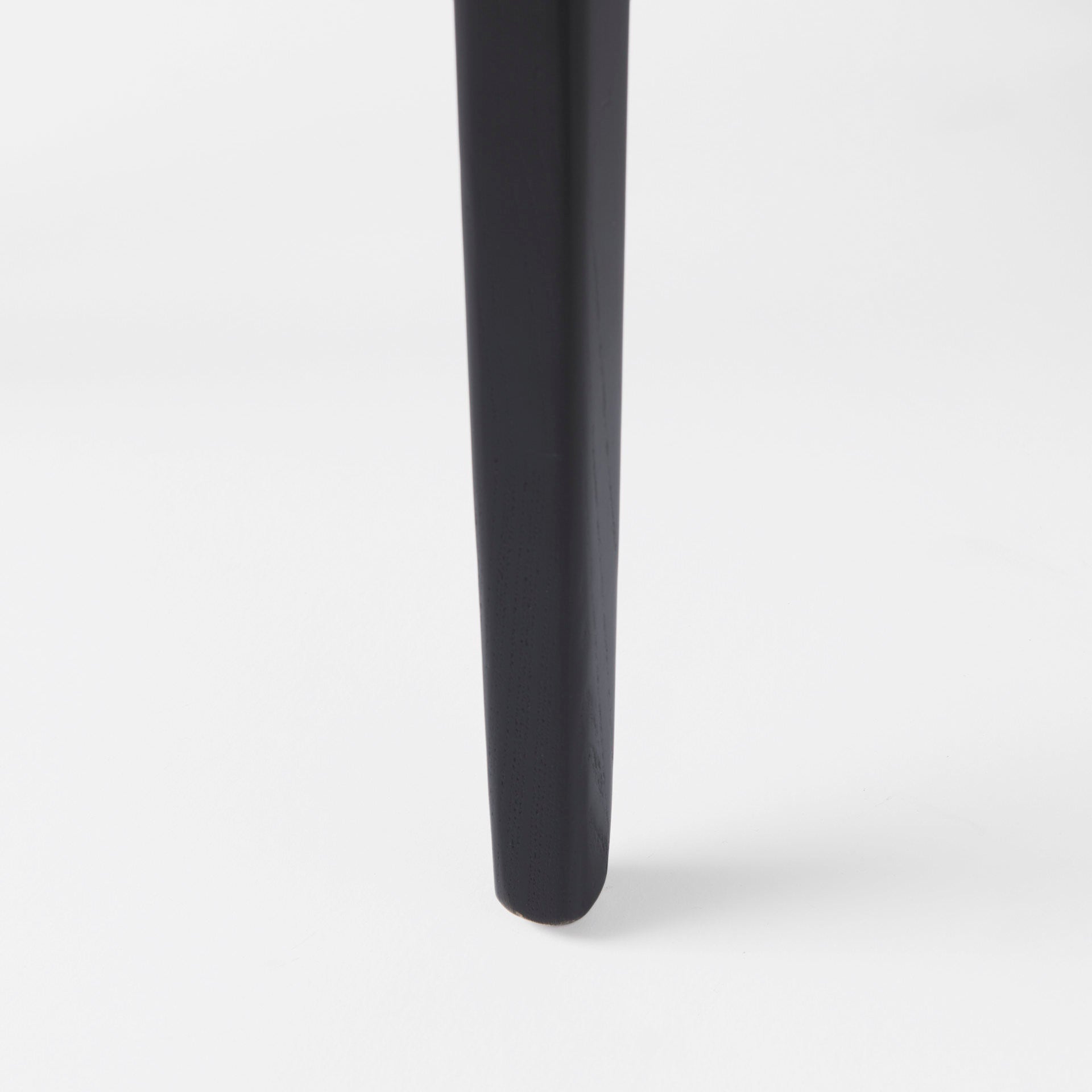 Close up of Clara Black Wood W/ Cream Fabric Seat and Cane Back Armless Dining Chair on a white background