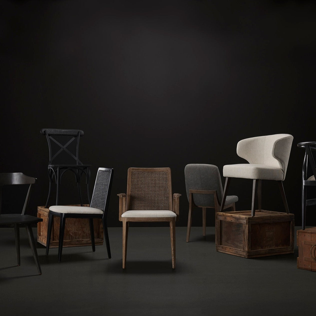 Collection of dining chairs against a black and grey  background