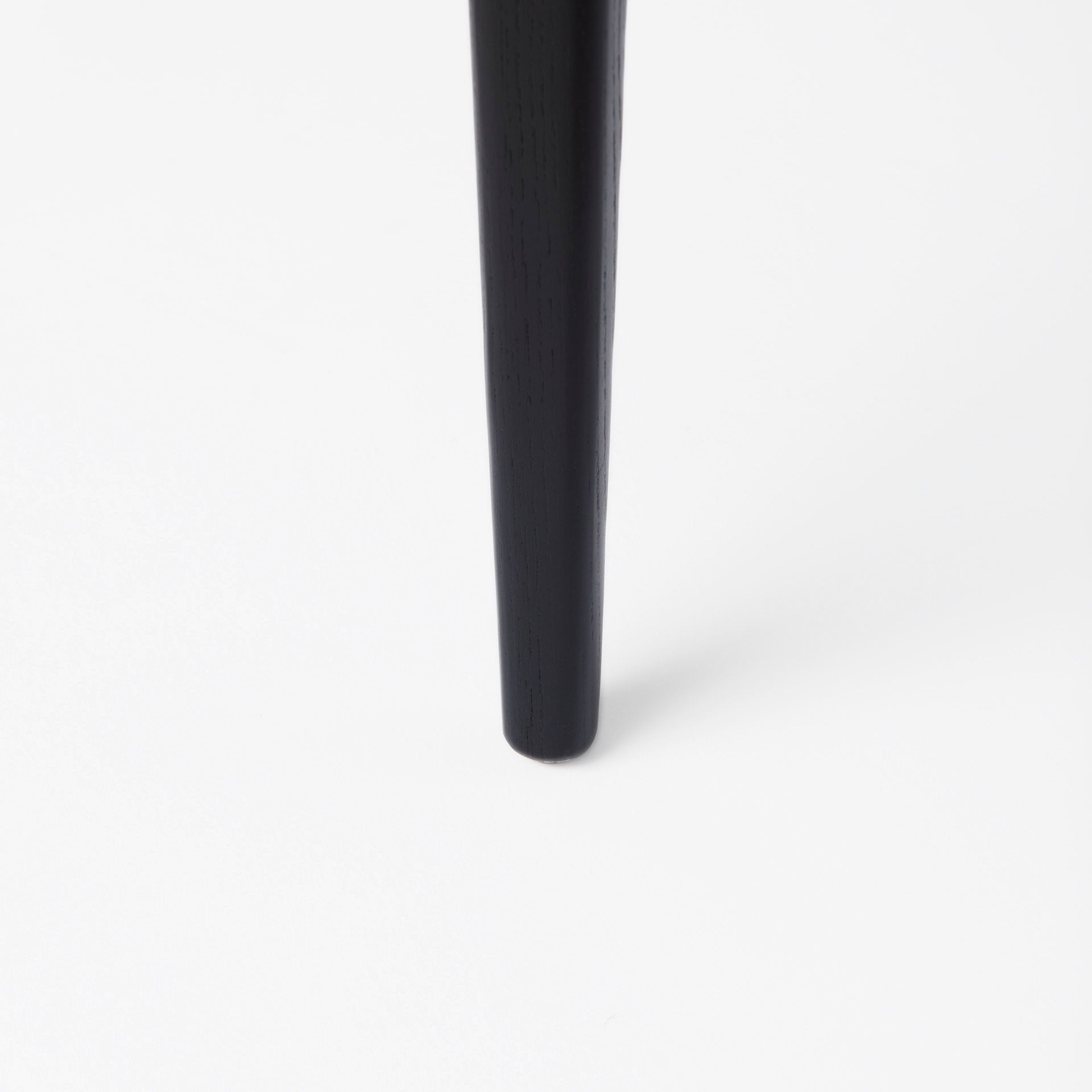 Close up of Clara Black Wood W/ Cream Fabric Seat and Cane Back Dining Chair on a white background