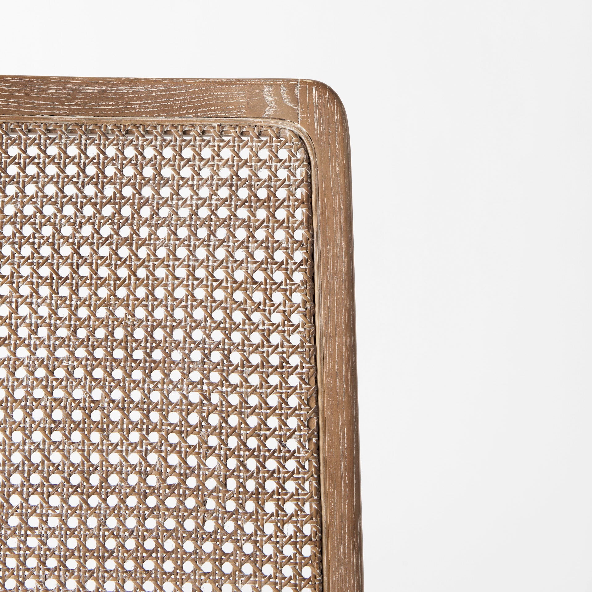 Close up of Clara Light Brown Wood W/ Cream Fabric Seat and Cane Back Armless Dining Chair on a white background