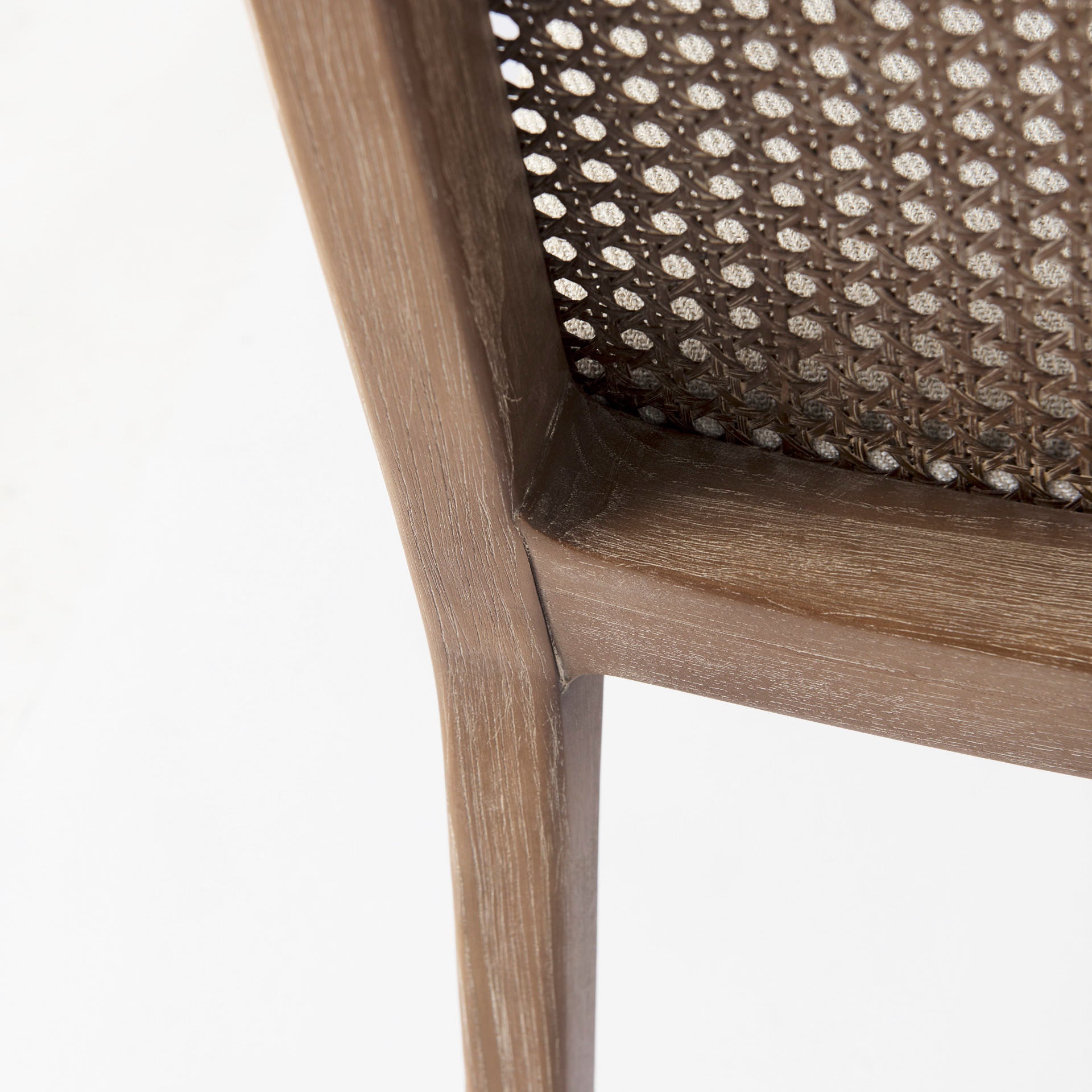 Close up of Clara Light Brown Wood W/ Cream Fabric Seat and Cane Back Armless Dining Chair on a white background