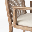 Clara Light Brown Wood W/ Cream Fabric Seat and Cane Back Dining Chair on a white background