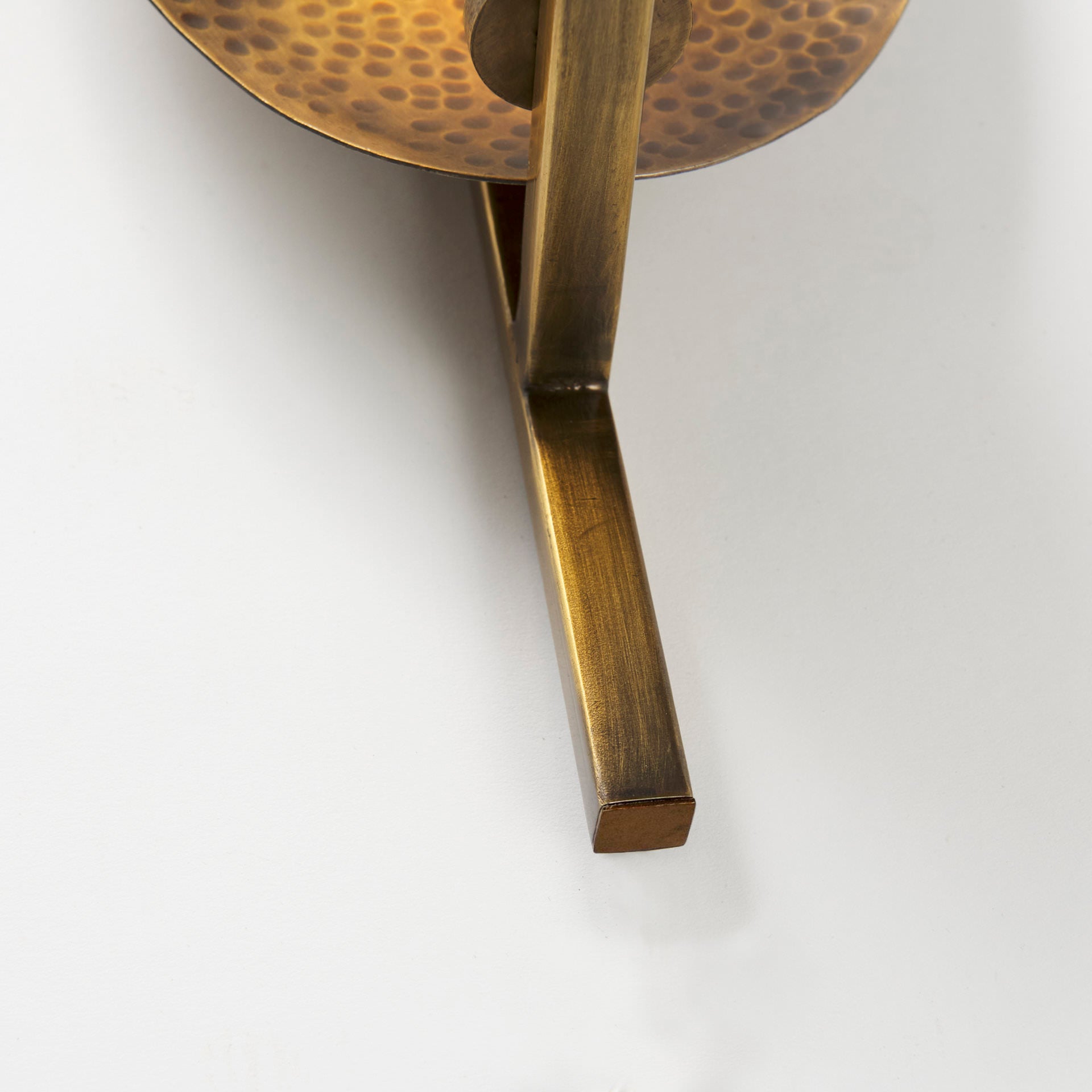 Close up of Clarence 7.0L x 5.3W x 17.0H Metal Hammered Gold Round Wall Sconce on a white background