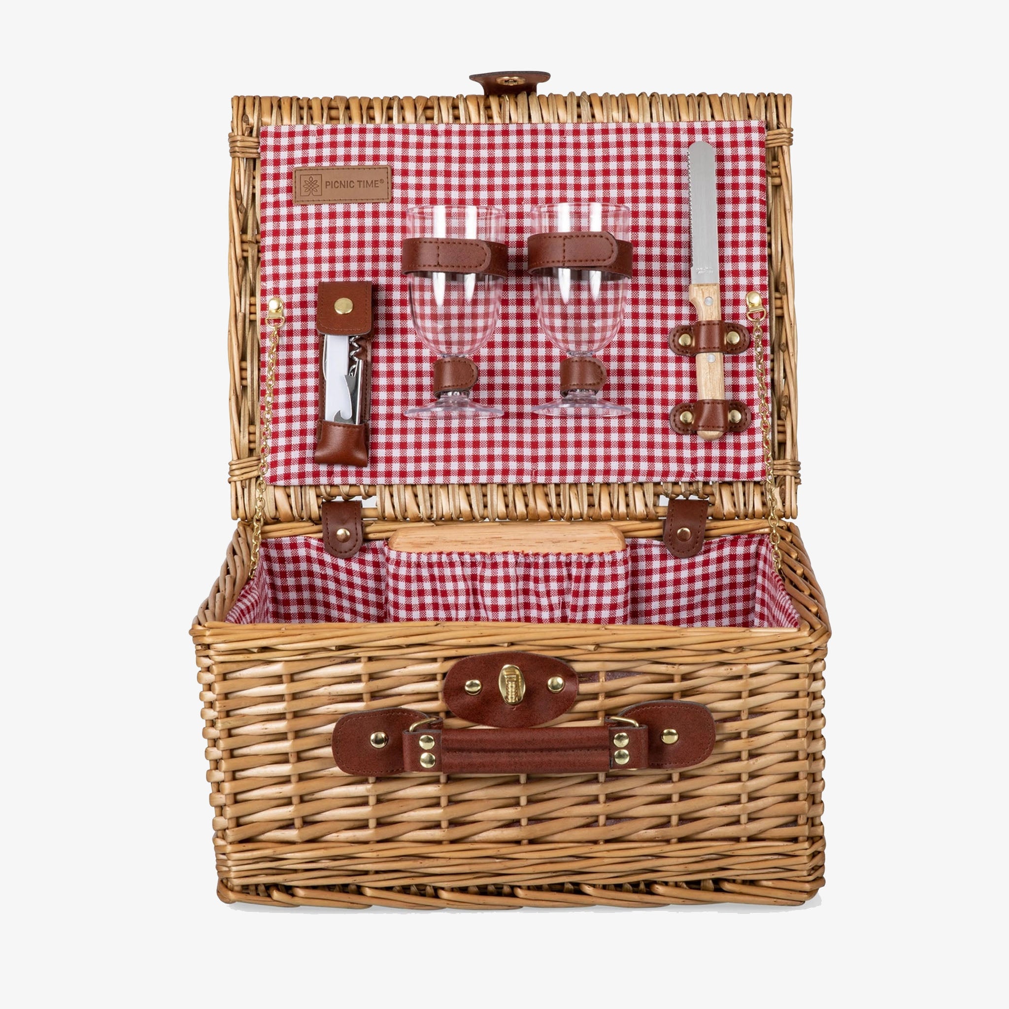 Wicker picnic basket with red checked interior and wine glasses on a white background
