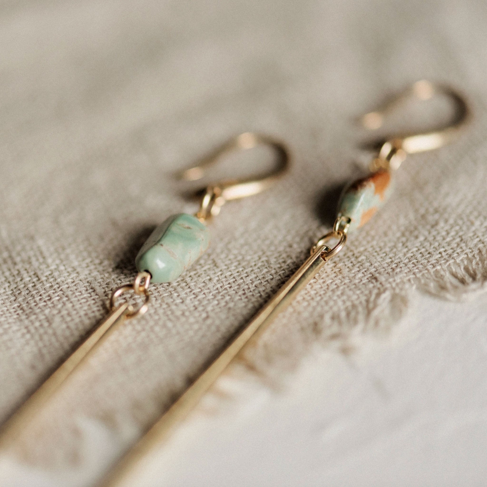 Commonform Passerine Earrings in Turquoise on textured background at the Addison West.