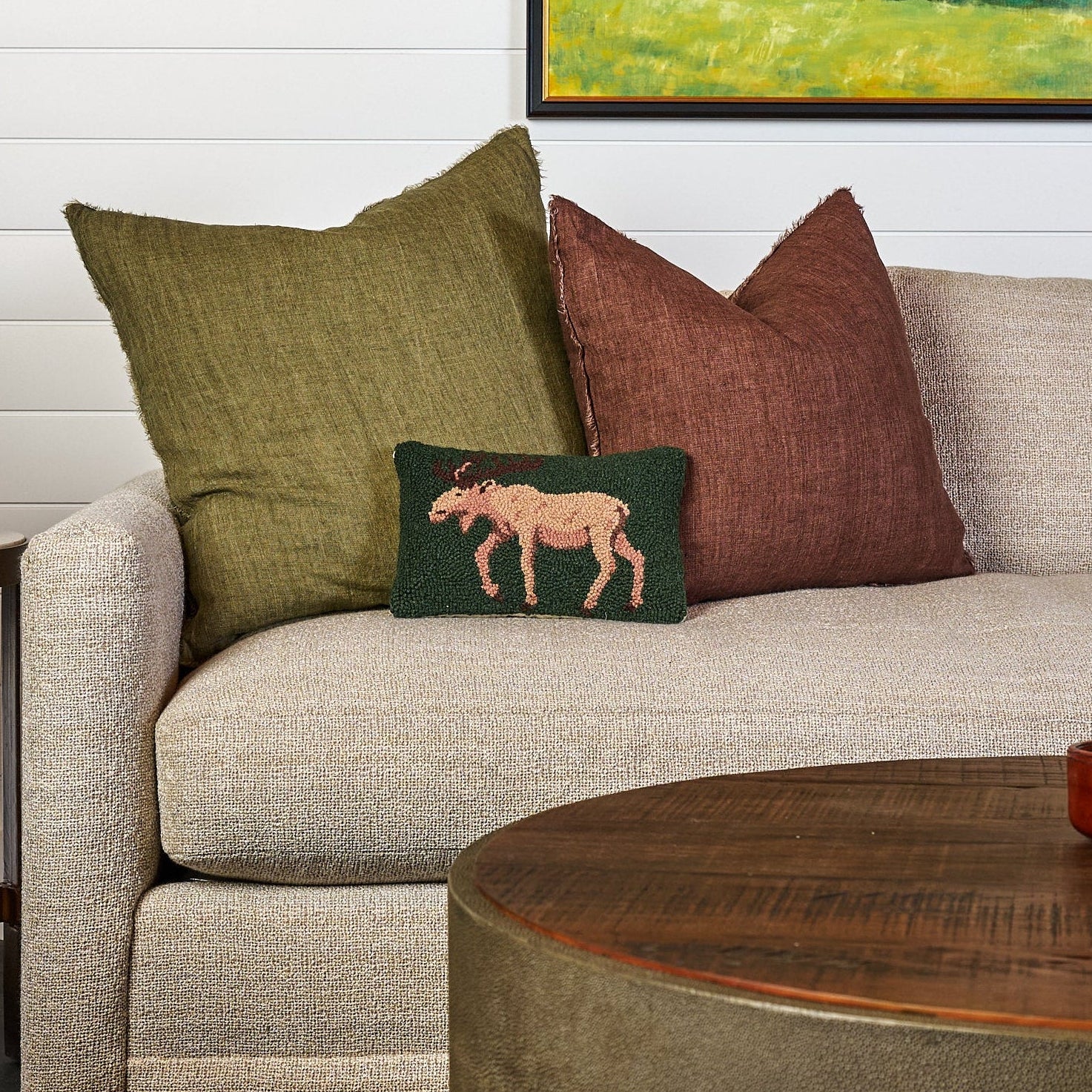 Moose Hand Hooked Pillow on a sofa at Addison West