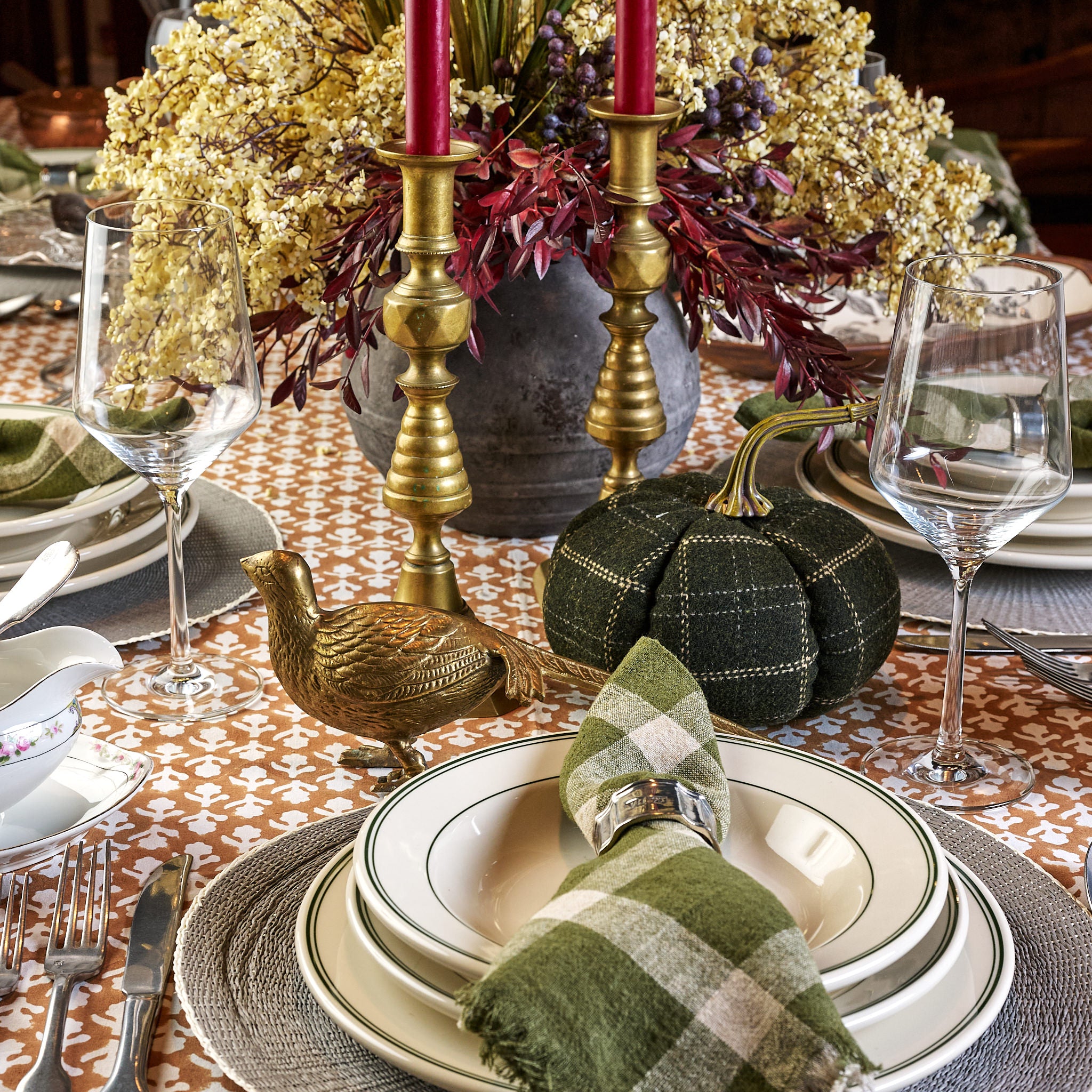 Large Green & Tan Plaid Pumpkin and Vintage brass pheasant and brass beehive candlesticks on a table at Addison West
