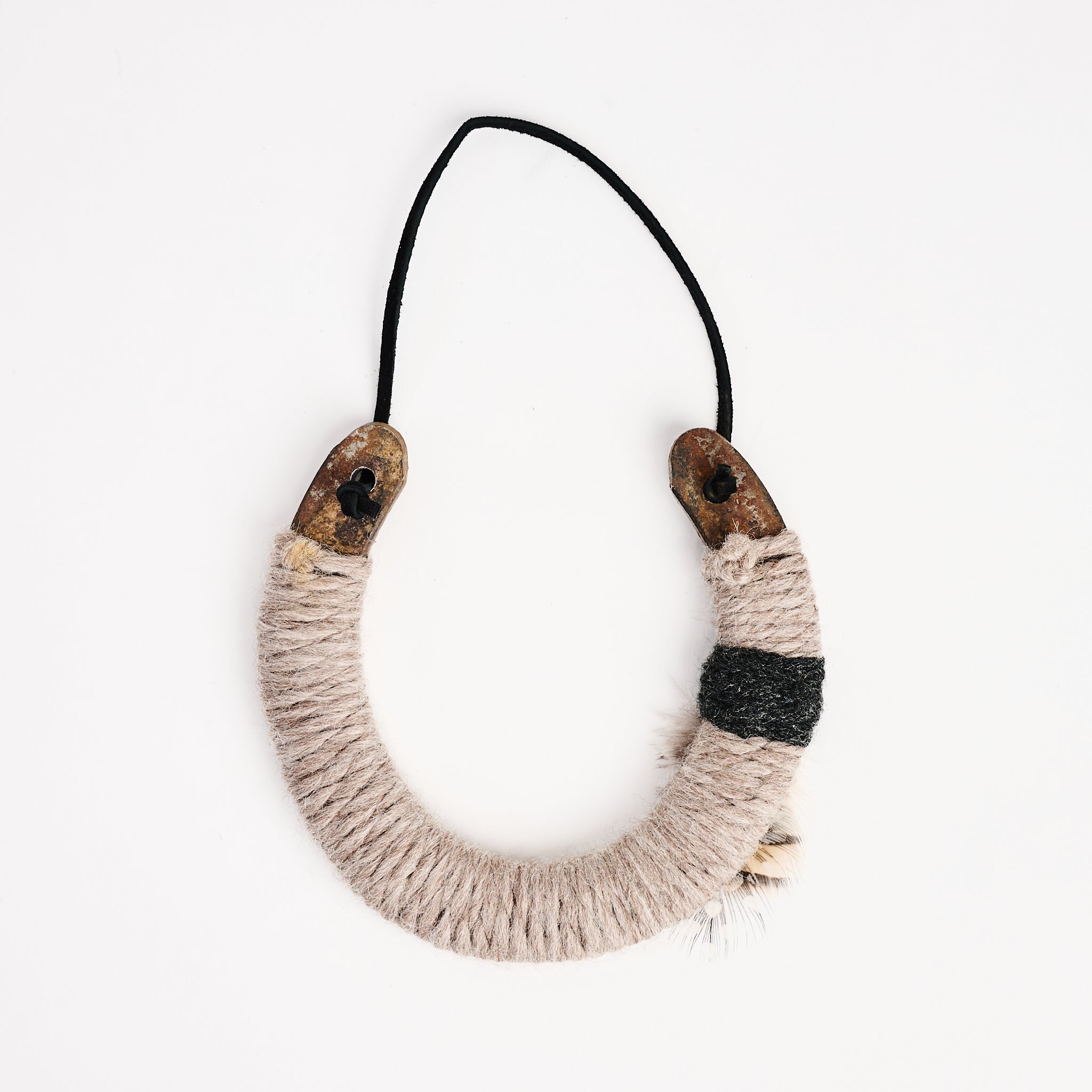 Upcycled Lucky Horseshoe in Beige Feather on a white background at Addison West