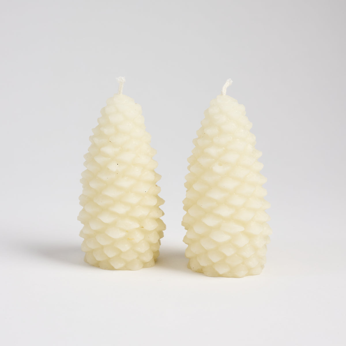 Pinecone Beeswax Candle in Cream on a white background at Addison West