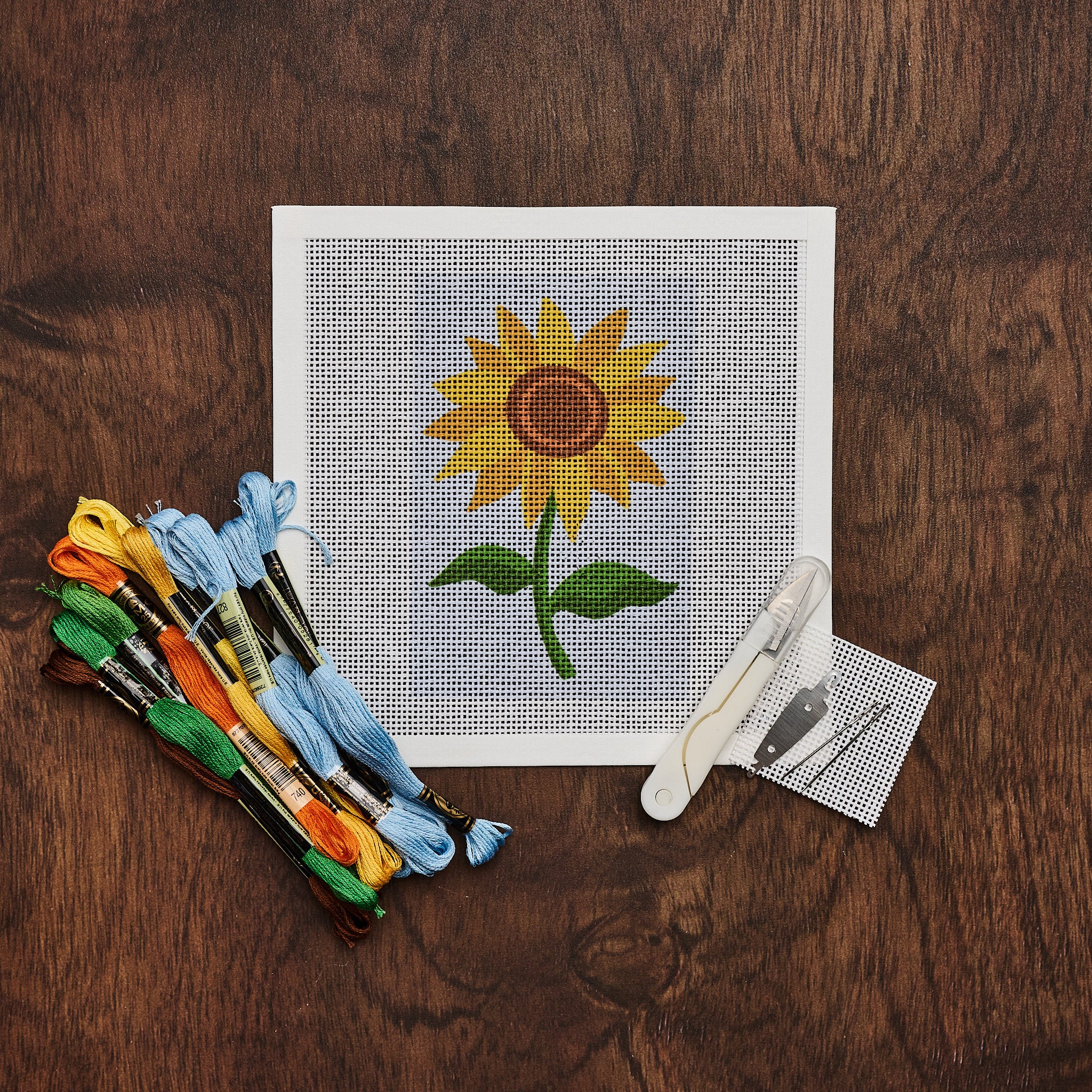 Sunflower Needlepoint Kit on a wood table at Addison West