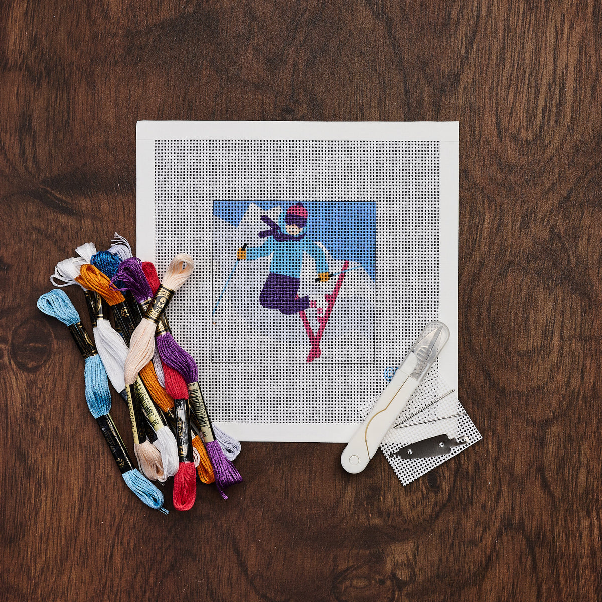 Snow Skier Needlepoint Kit on a wood table at Addison West