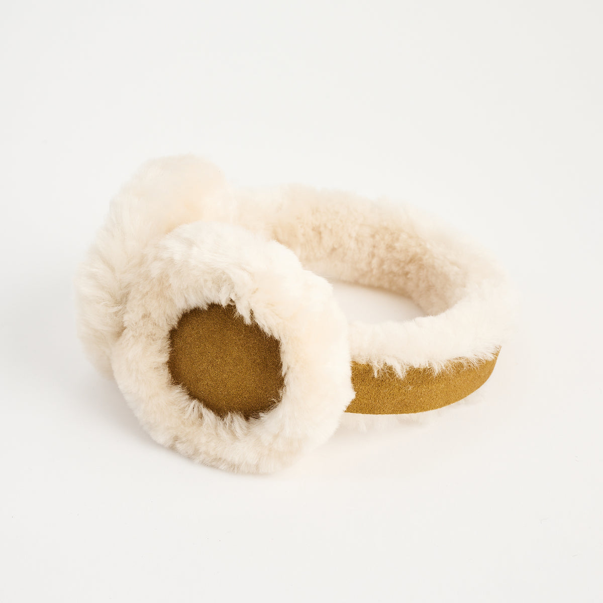 Lambswool And Suede Earmuffs in Camel on a white background at Addison West