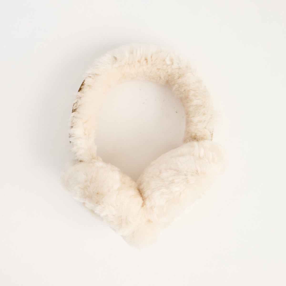 Lambswool And Suede Earmuffs in Camel on a white background at Addison West