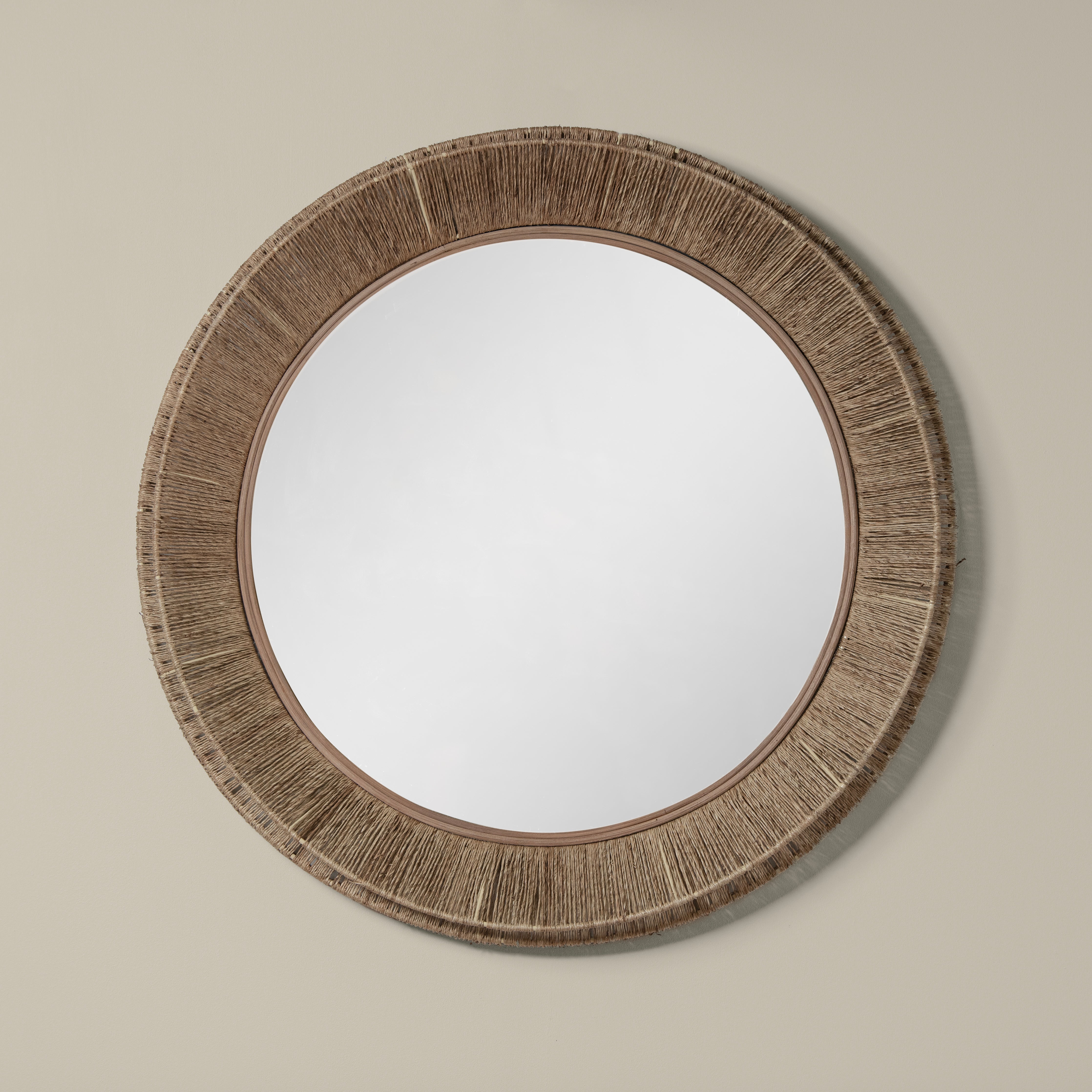 Collins Large Jute Mirror in Natural on a beige wall at Addison West