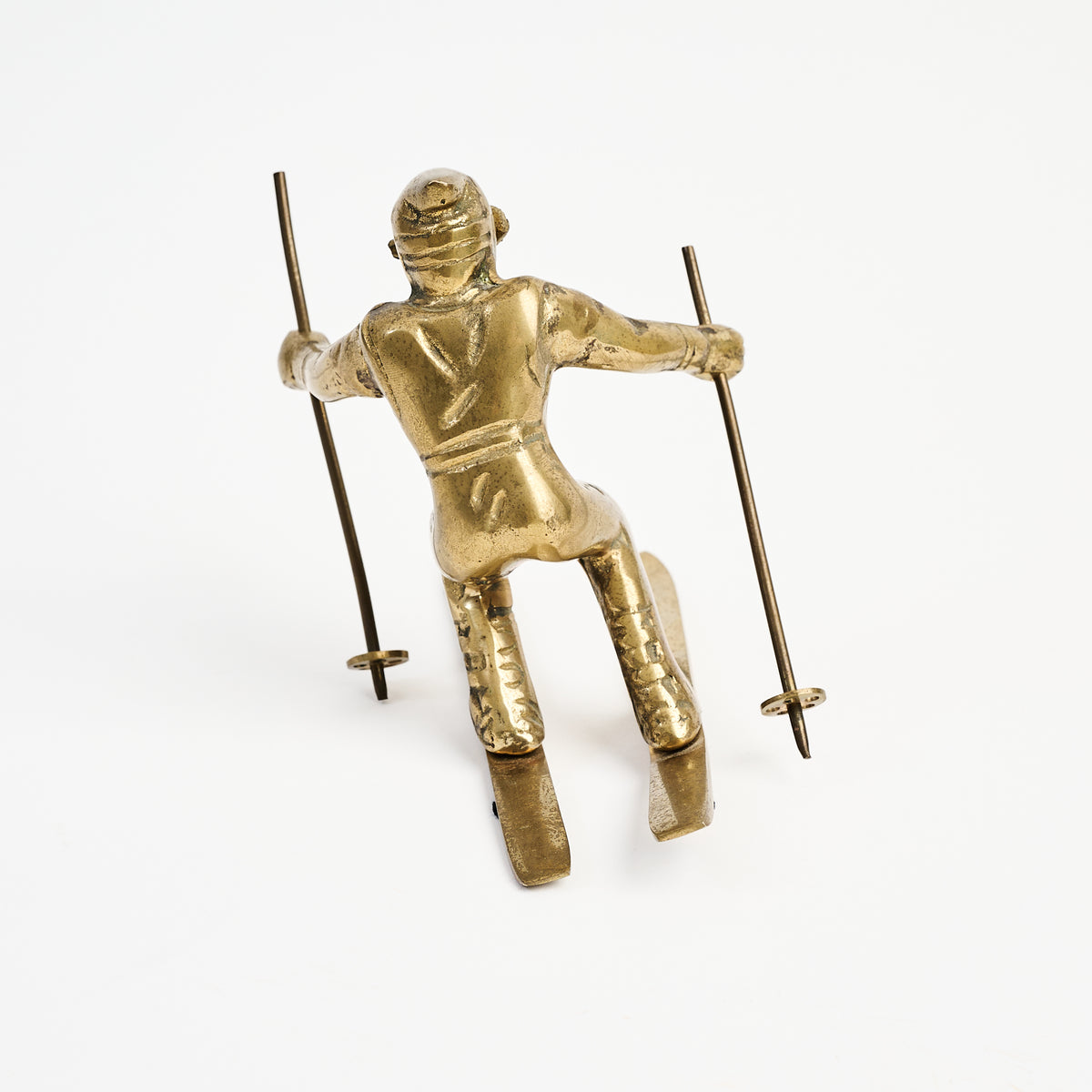 Vintage Brass Skier on a white background at Addison West